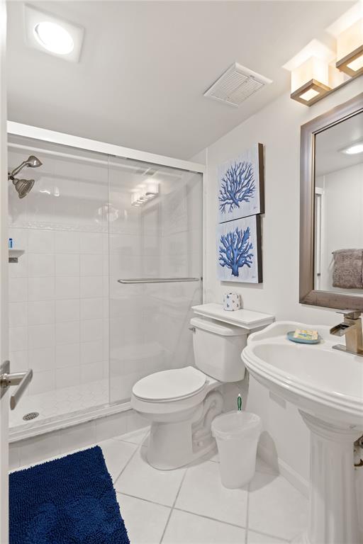 8630 Midnight Pass Road, Unit 103A Sarasota, FL 34242 - Photo 12 of 44 a bathroom with a sink toilet and shower