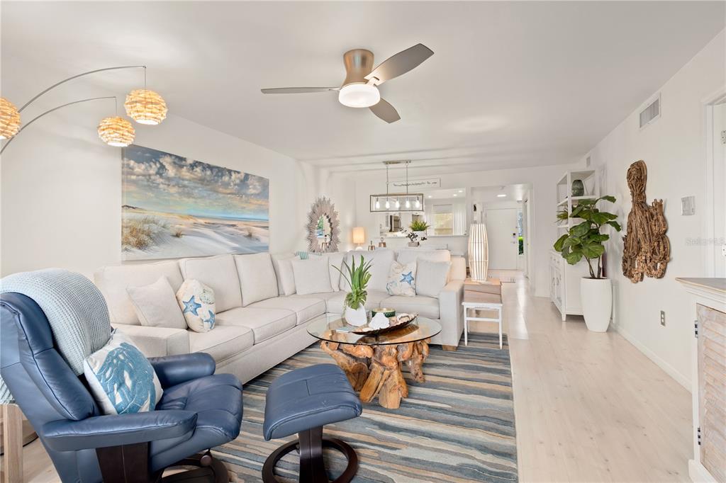 8630 Midnight Pass Road, Unit 103A Sarasota, FL 34242 - Photo 13 of 44 a living room with furniture and a chandelier