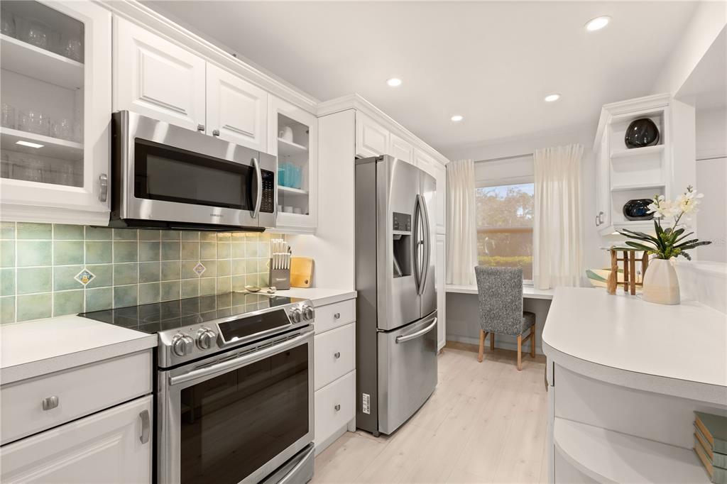8630 Midnight Pass Road, Unit 103A Sarasota, FL 34242 - Photo 18 of 44 a kitchen with a sink stainless steel appliances and cabinets