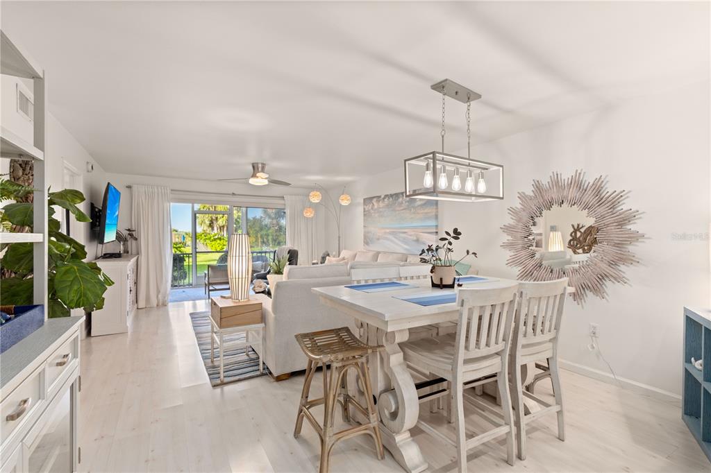 8630 Midnight Pass Road, Unit 103A Sarasota, FL 34242 - Photo 7 of 44 a view of a dining room with furniture window and outside view