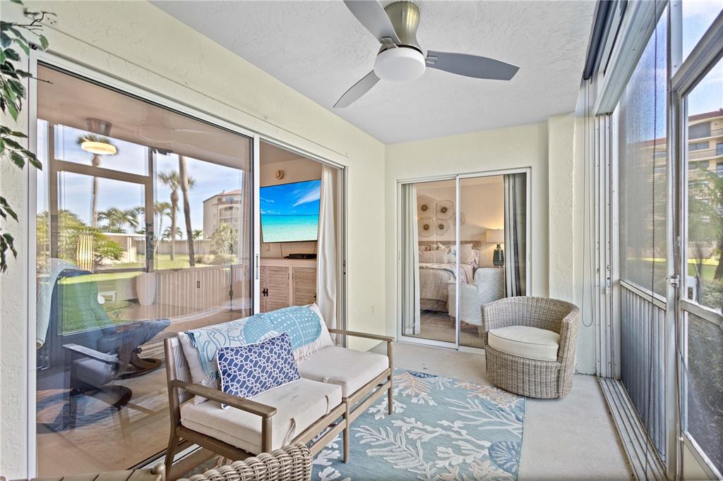 8630 Midnight Pass Road, Unit 103A Sarasota, FL 34242 - Photo 9 of 44 a living room with furniture and a large window