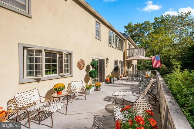 a front view of a house with outdoor seating
