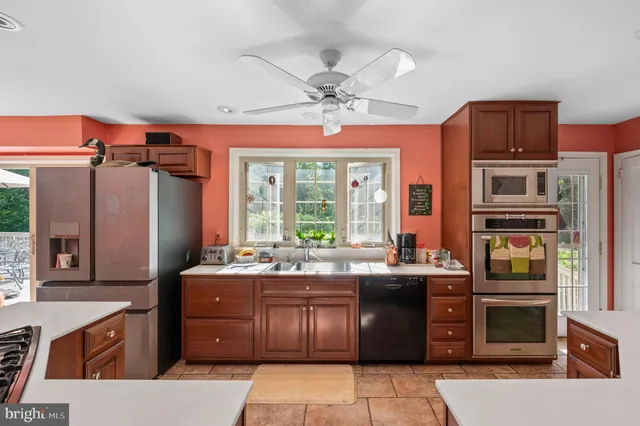 a kitchen with a stove a sink and a refrigerator