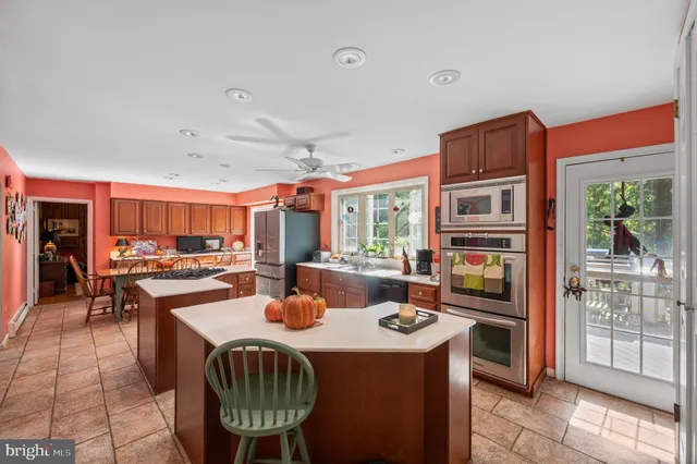 a kitchen with a stove a refrigerator and a dining table