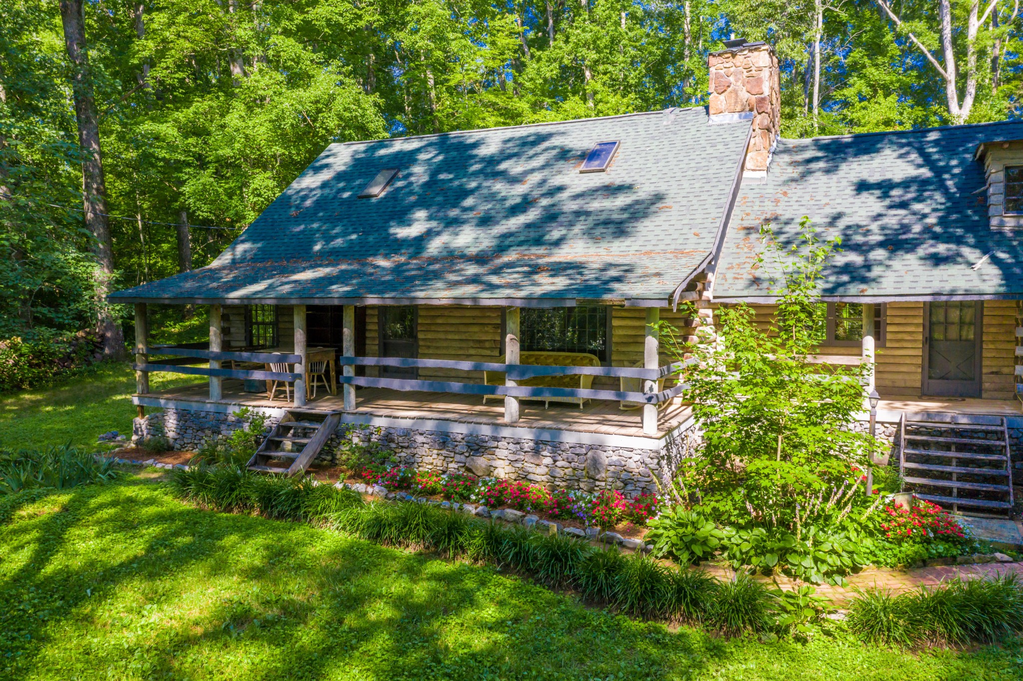 145 Scruggs Cemetery Road Clinton, TN 37716 - Photo 3 of 26 a view of a house with backyard sitting area and garden