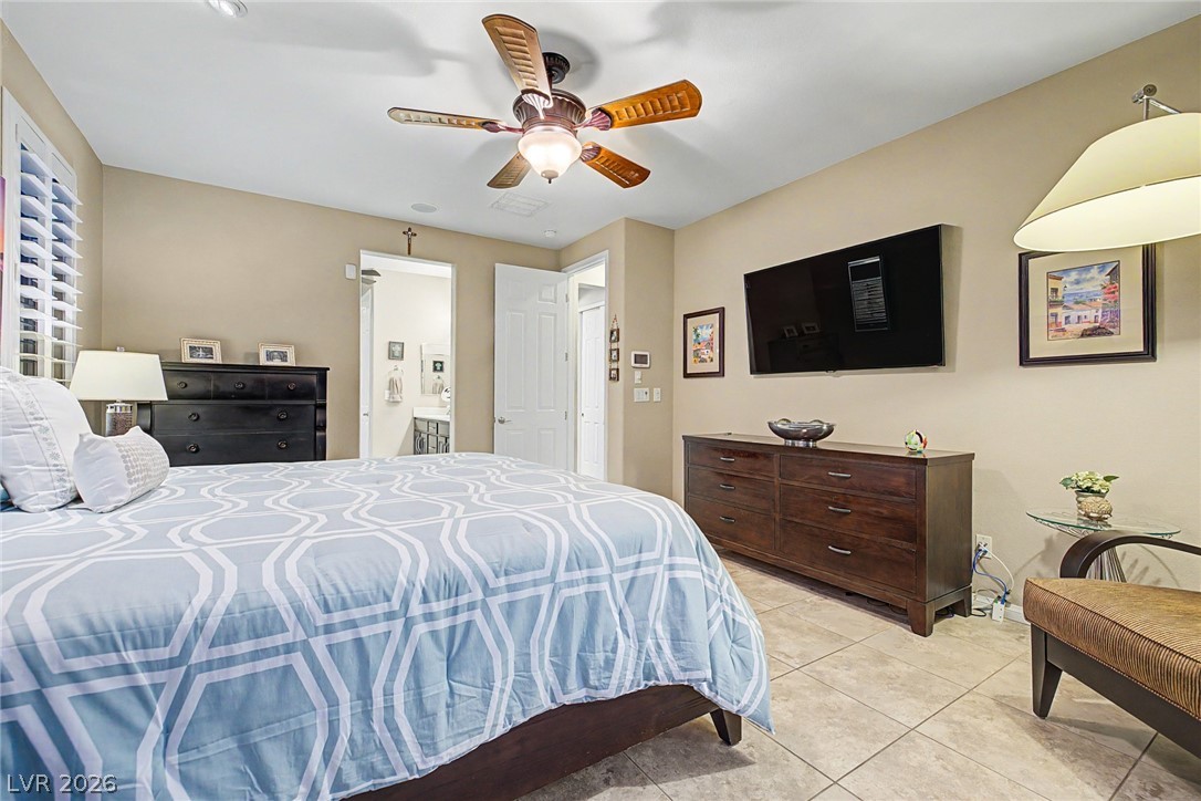 7415 Campbell Ranch Avenue Las Vegas, NV 89179 - Photo 31 of 52 Relaxing sleeping quarters with a ceiling fan, tiled floors, and abundant natural light.