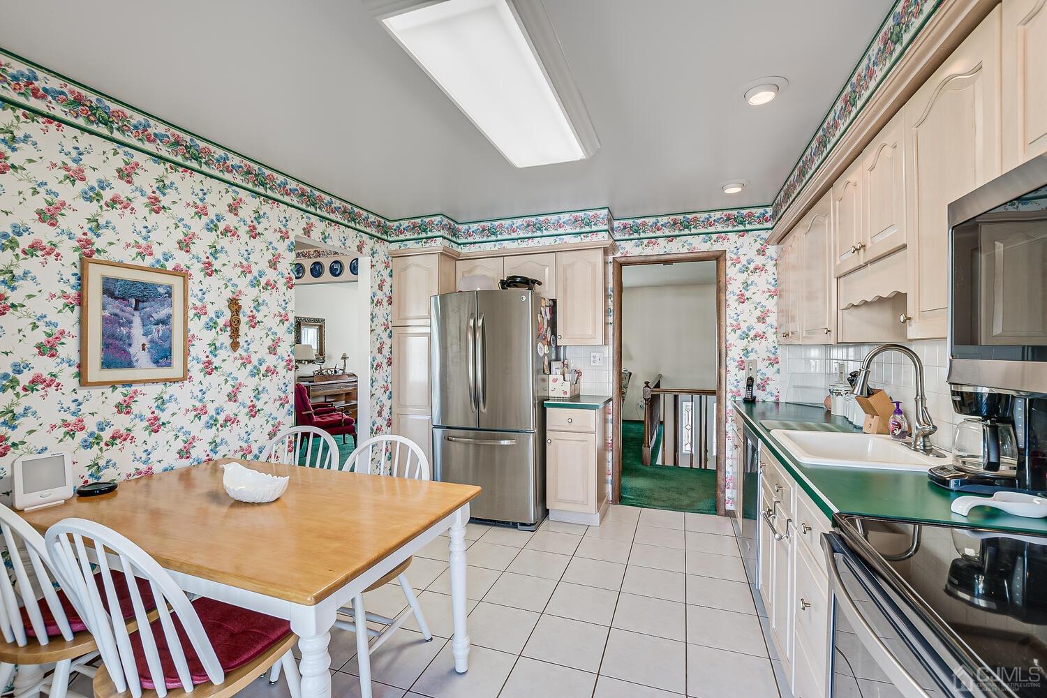 30 Baltic Street Edison, NJ 08820 - Photo 18 of 42 a kitchen that has a lot of cabinets a sink and a refrigerator