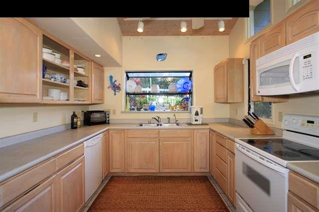 180 Kapuai Road Haiku, HI 96708 - Photo 10 of 29 a kitchen with a sink and cabinets