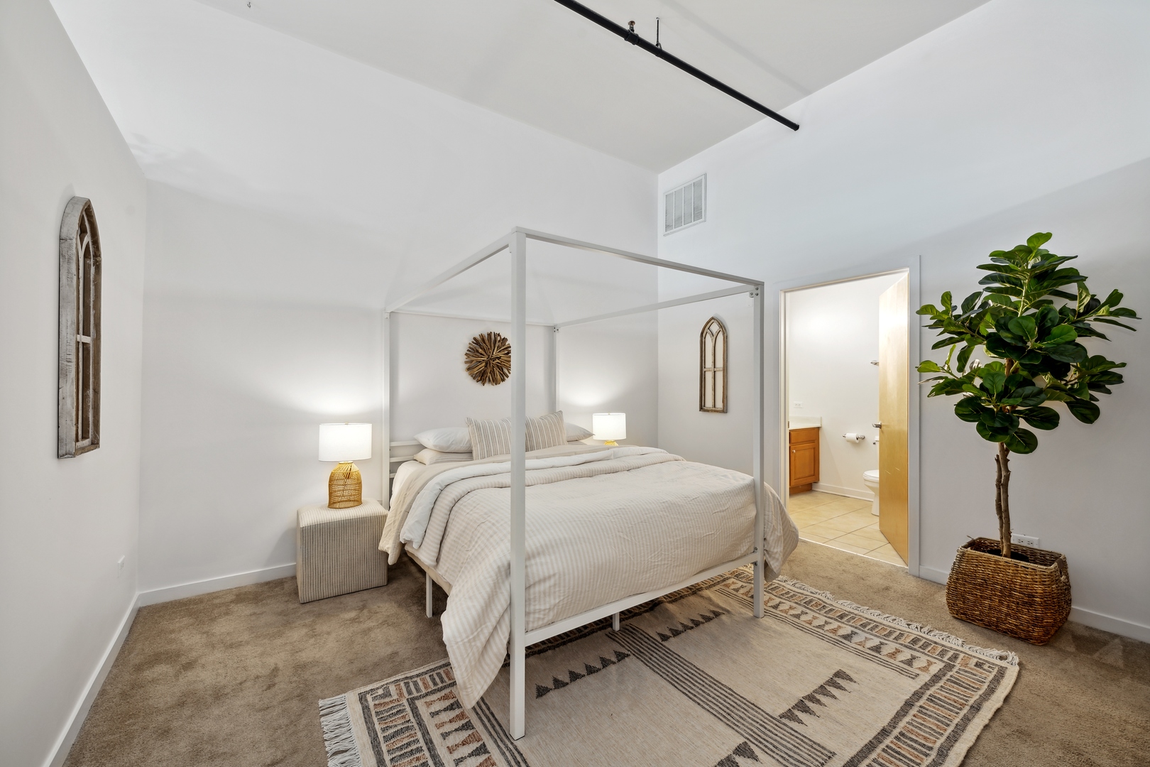 1224 West Van Buren Street, Unit 810 Chicago, IL 60607 - Photo 14 of 28 a bedroom with a bed and a potted plant