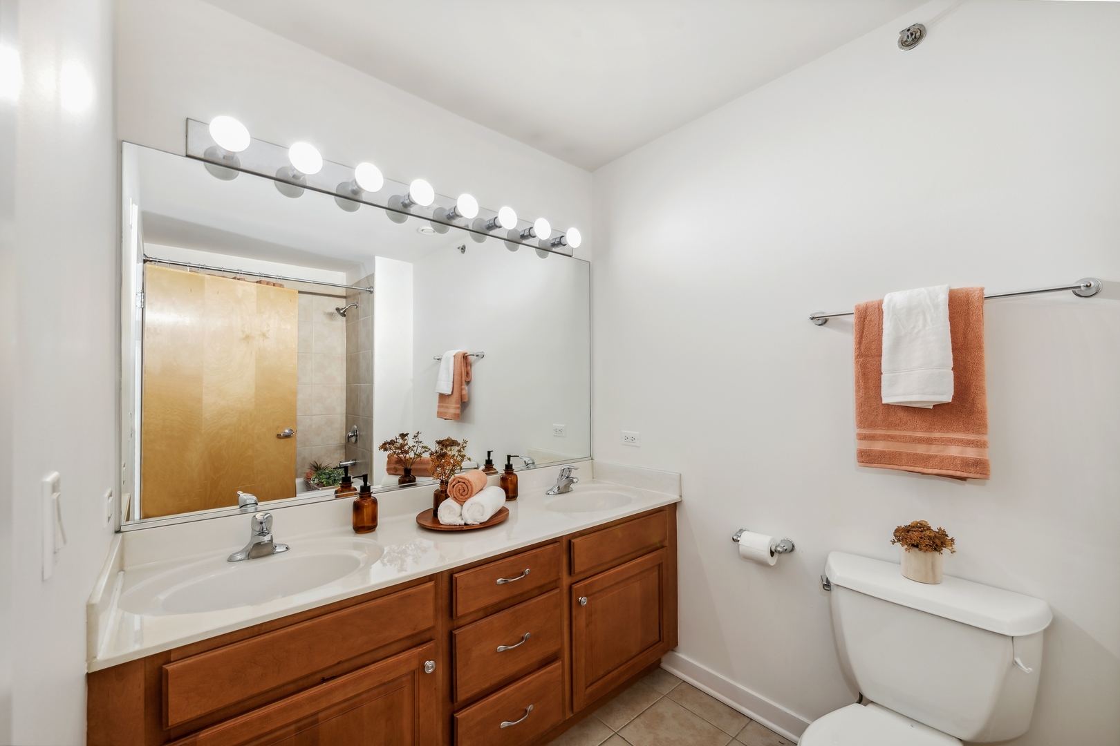 1224 West Van Buren Street, Unit 810 Chicago, IL 60607 - Photo 17 of 28 a bathroom with a toilet sink and mirror