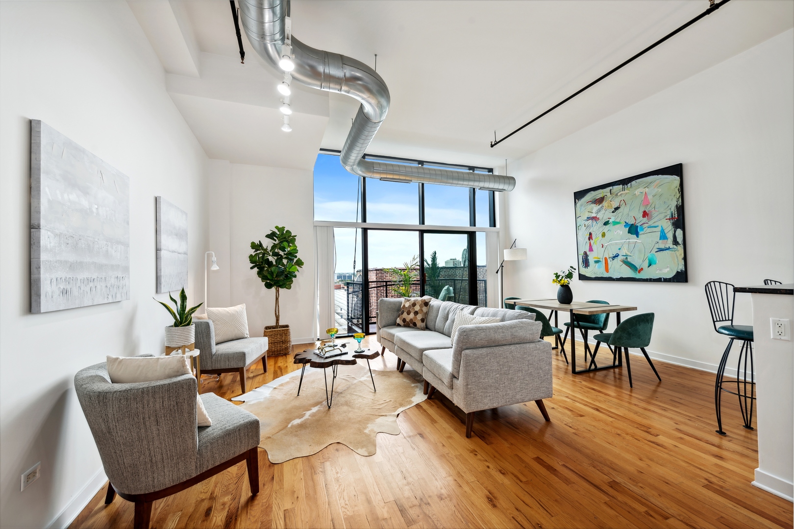 1224 West Van Buren Street, Unit 810 Chicago, IL 60607 - Photo 2 of 28 a living room with furniture and a wooden floor