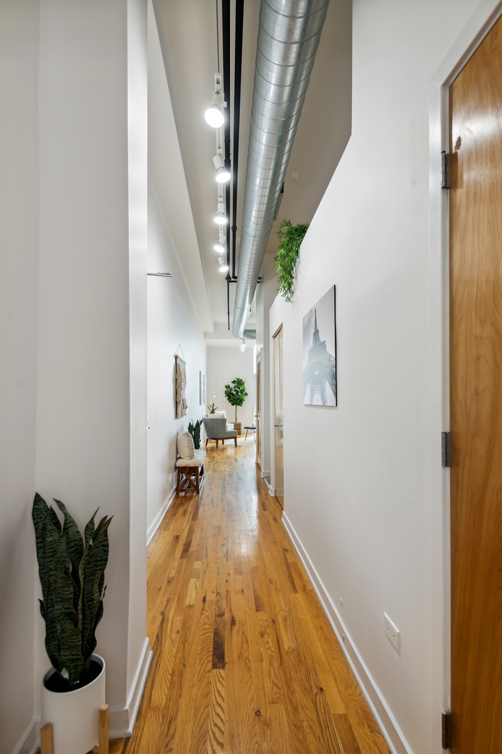 1224 West Van Buren Street, Unit 810 Chicago, IL 60607 - Photo 21 of 28 a hallway with a dining table and chairs