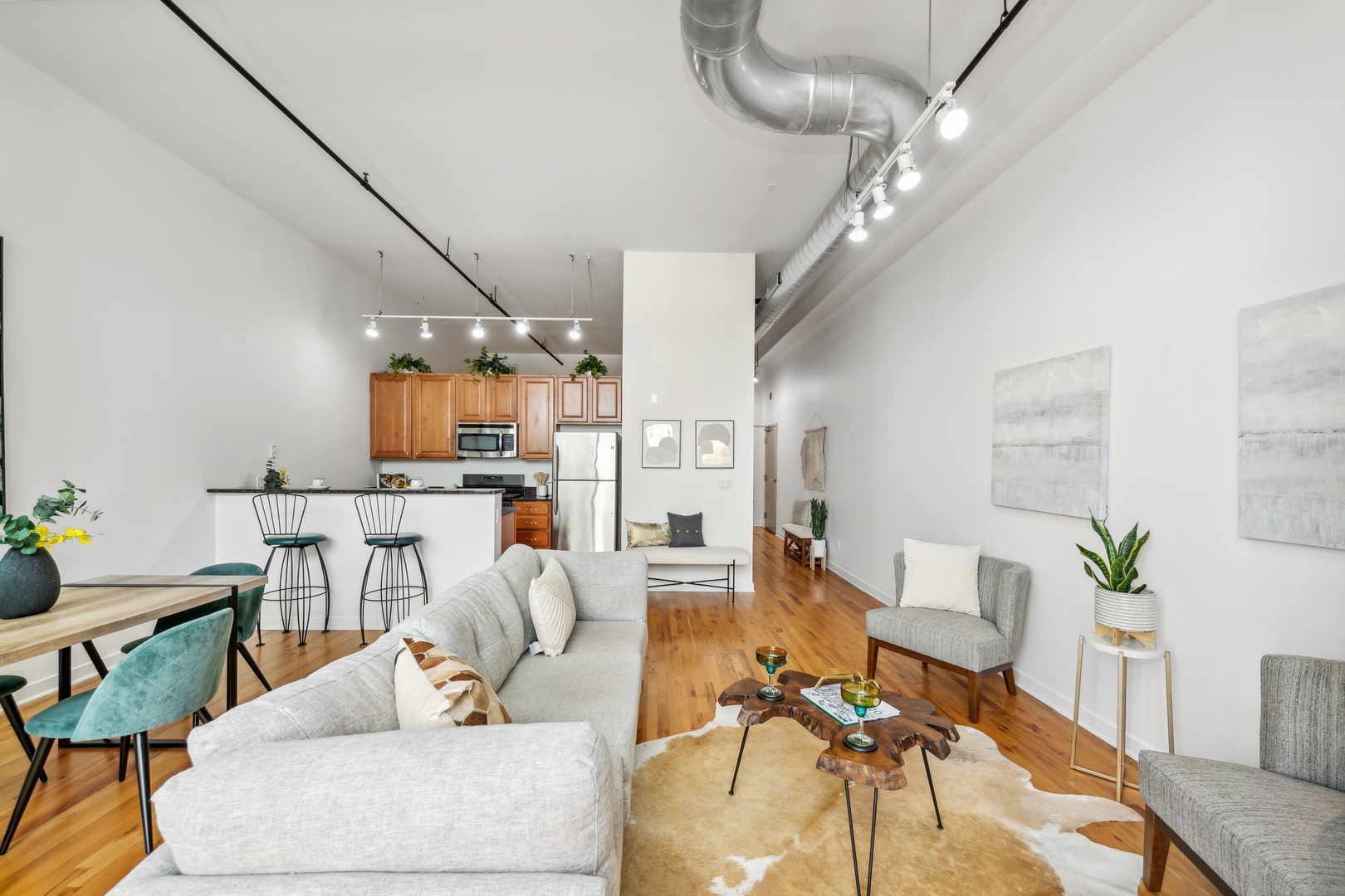 1224 West Van Buren Street, Unit 810 Chicago, IL 60607 - Photo 22 of 28 a living room with furniture and a chandelier