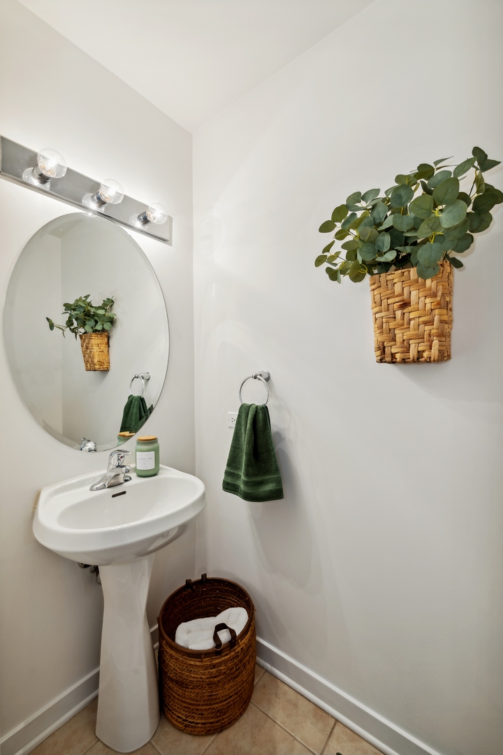 1224 West Van Buren Street, Unit 810 Chicago, IL 60607 - Photo 25 of 28 a bathroom with a sink and mirror