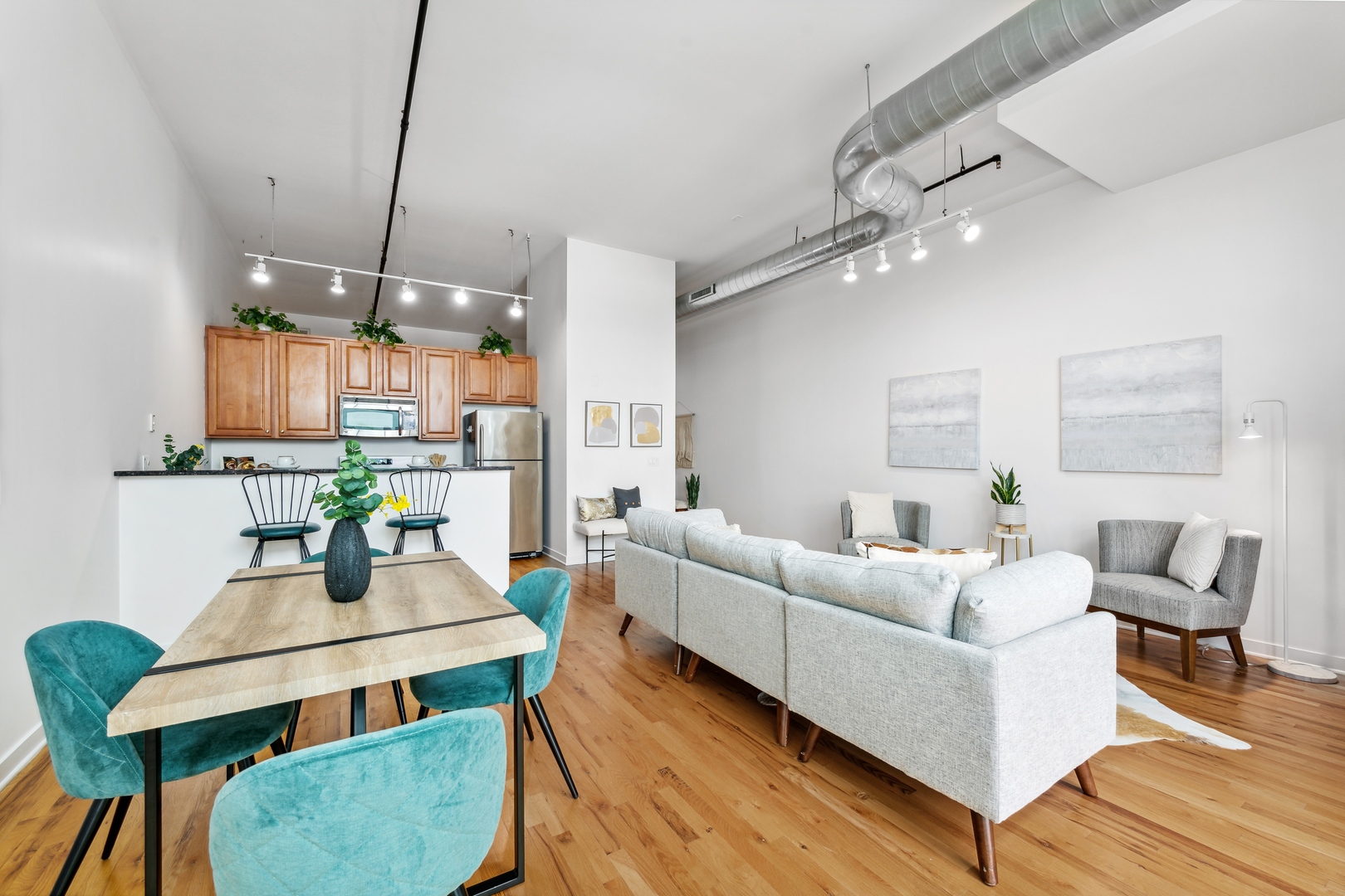 1224 West Van Buren Street, Unit 810 Chicago, IL 60607 - Photo 5 of 28 a living room with furniture kitchen view and a chandelier