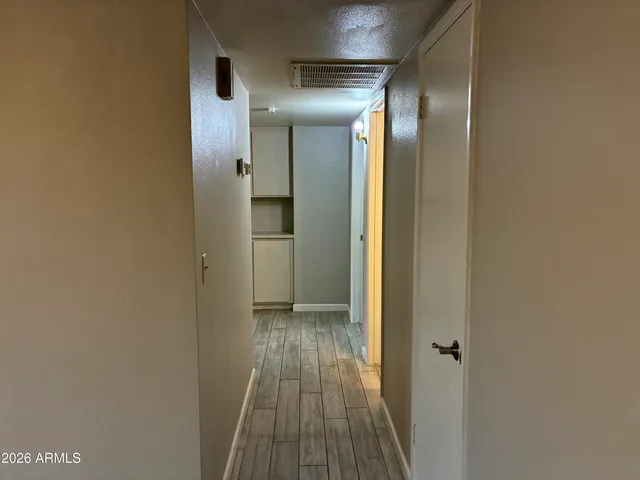 a view of hallway with wooden floor