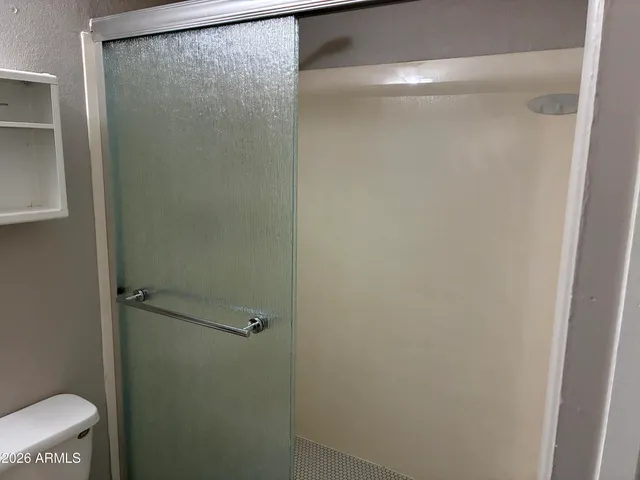 a bathroom with a glass shower door