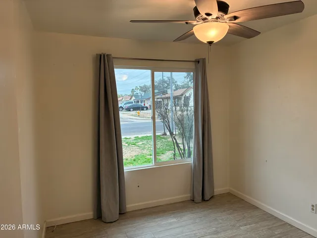 a view of a livingroom with a ceiling fan and a large window