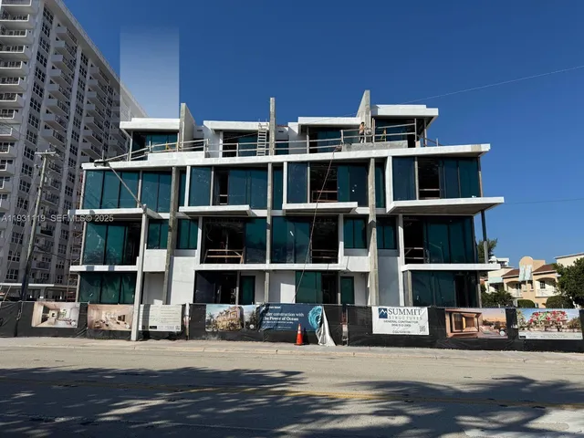 a front view of a building with a garden