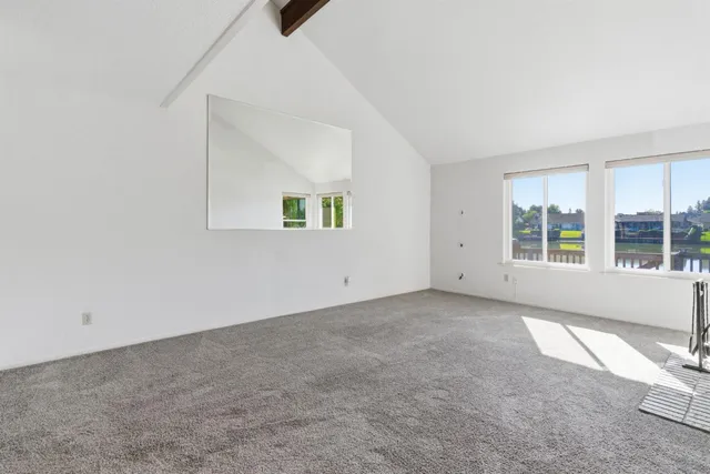 an empty room with windows and view of an empty room