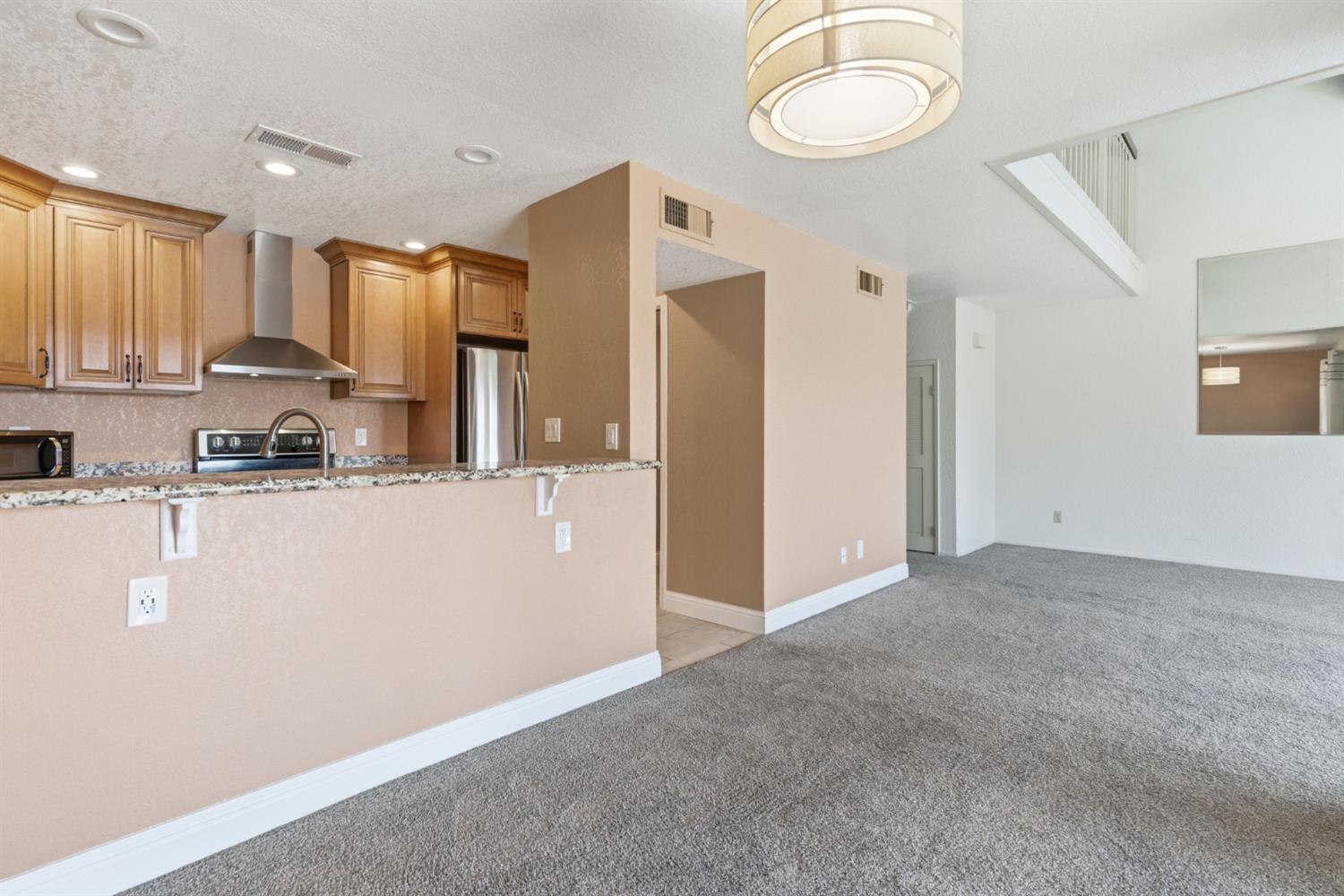 7348 Lighthouse Drive Stockton, CA 95219 - Photo 20 of 56 a view of kitchen with stainless steel appliances granite countertop refrigerator stove top oven and cabinets