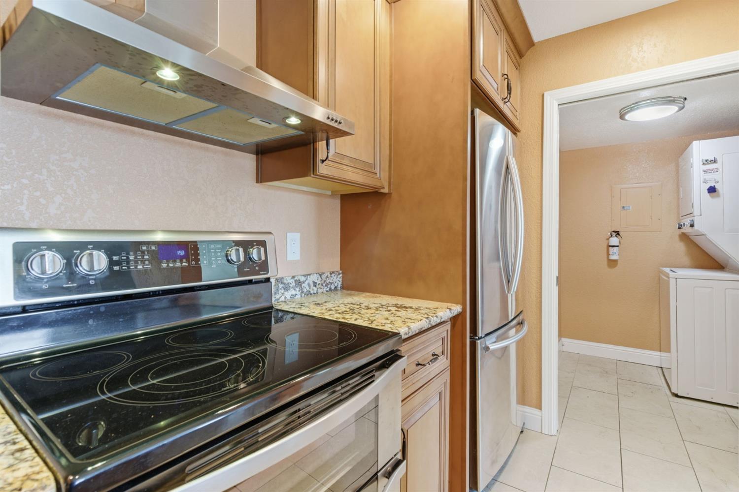 7348 Lighthouse Drive Stockton, CA 95219 - Photo 25 of 56 a kitchen with stainless steel appliances granite countertop a stove and a refrigerator