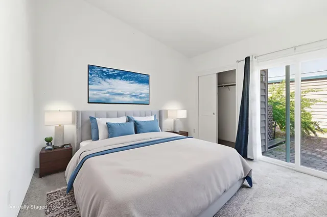 an empty room with windows and fireplace