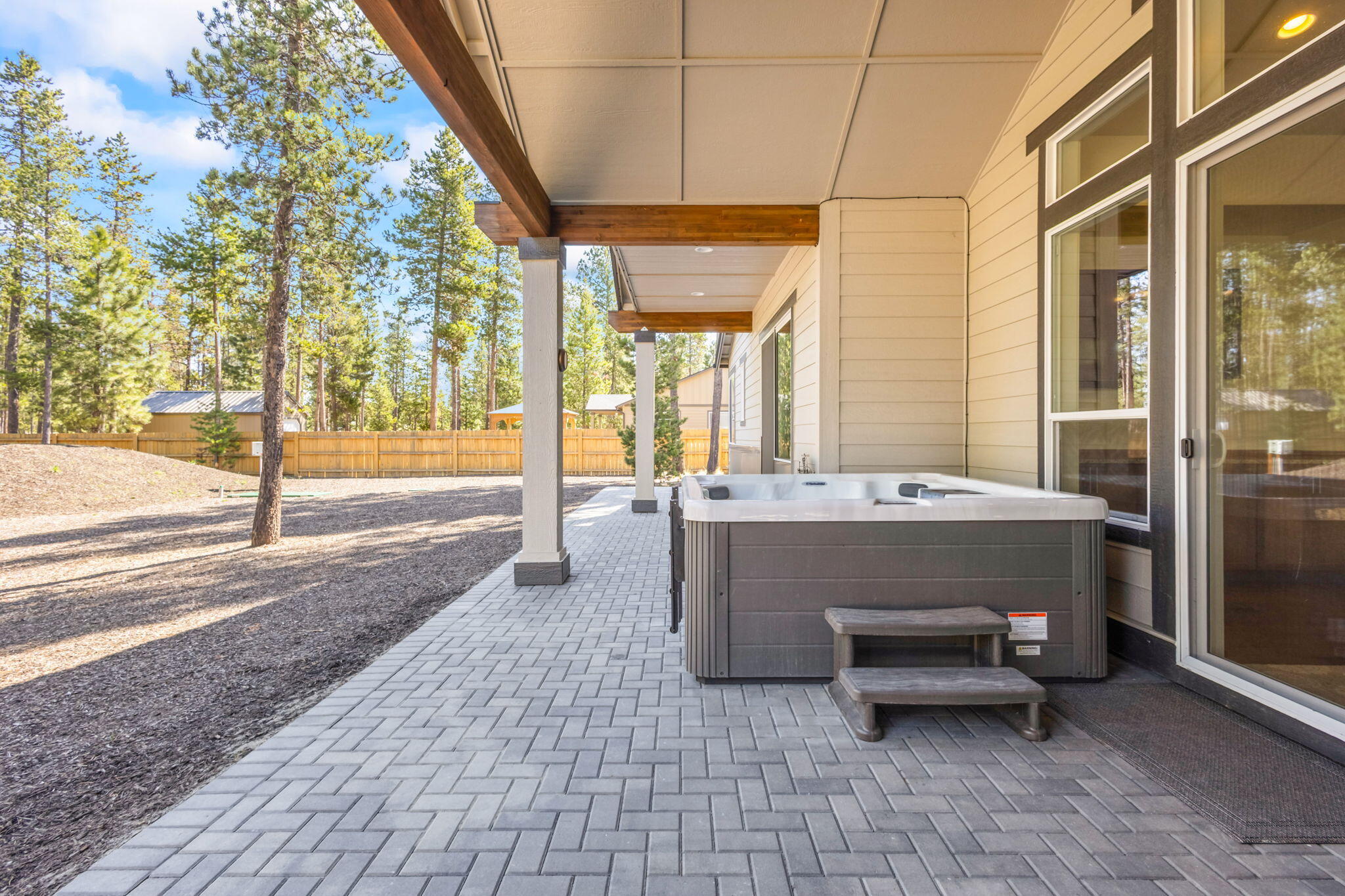 17138 Downey Road Bend, OR 97707 - Photo 36 of 57 Craftsman-style architecture with a covered patio and hot tub, perfect for relaxation amidst nature.