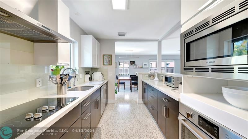 a kitchen with counter top space a sink stainless steel appliances and cabinets