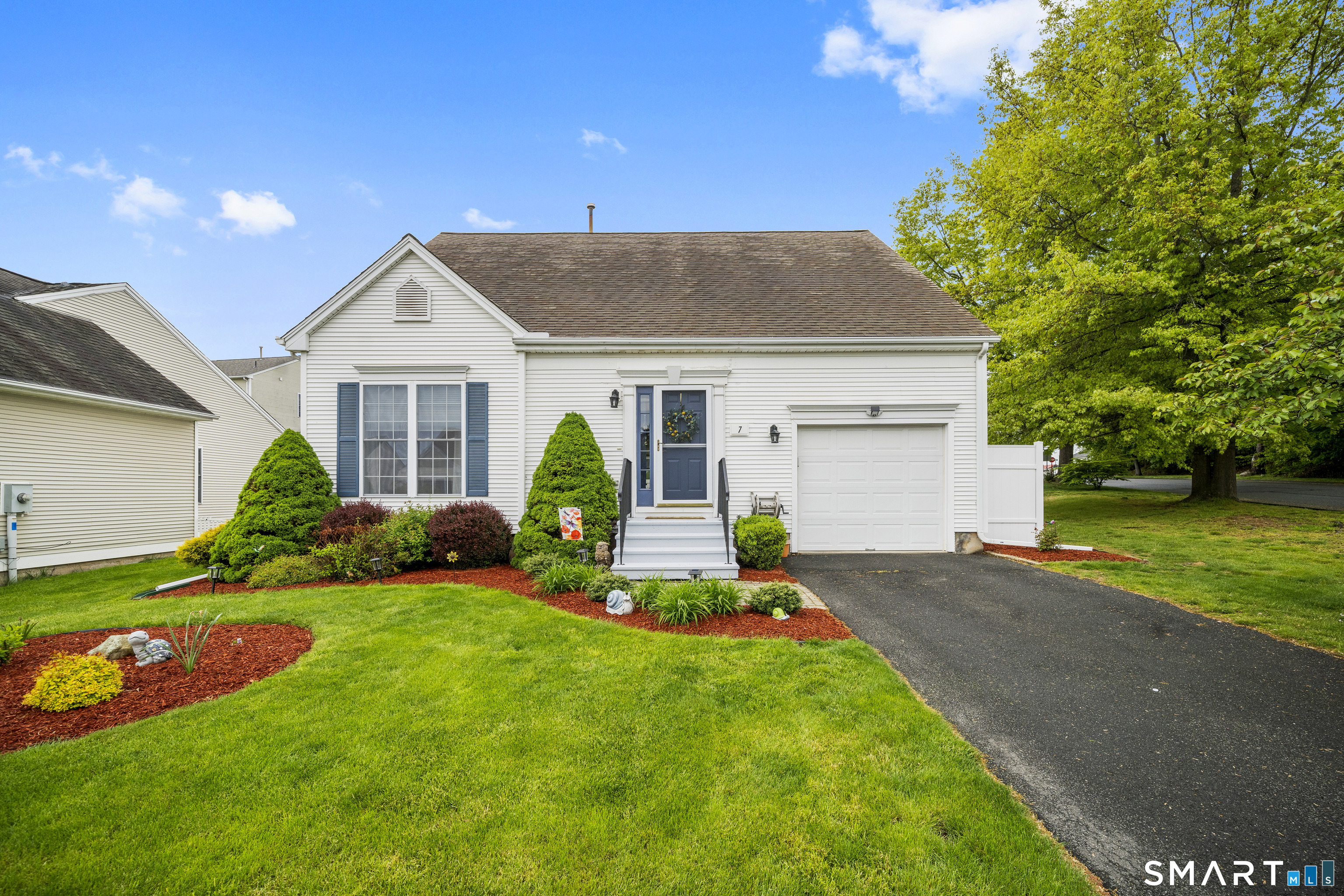 7 Heather Lane, Unit 7 Suffield, CT 06078 - Photo 1 of 34 a front view of a house with a yard and garage