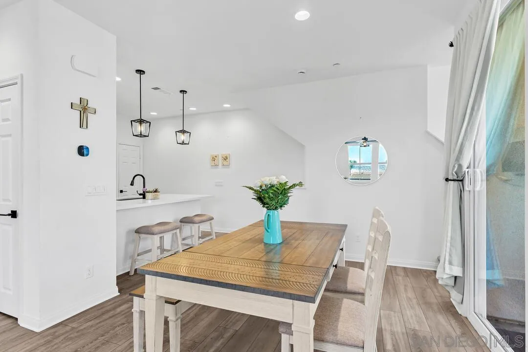 2811 Safflower Street Spring Valley, CA 91977 - Photo 9 of 28 a view of a dining room with furniture and wooden floor
