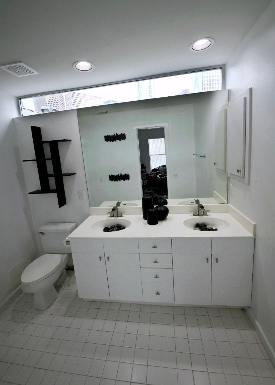 702 Ruthven Street Houston, TX 77019 - Photo 17 of 18 a spacious bathroom with a double vanity sink mirror and toilet