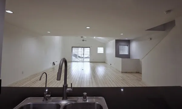 a kitchen with stainless steel appliances a stove a sink and a refrigerator