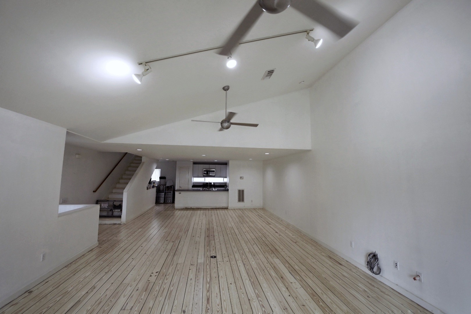 702 Ruthven Street Houston, TX 77019 - Photo 7 of 18 an empty room with wooden floor and ceiling fan