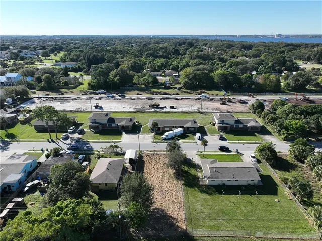 a view of multiple houses with yard