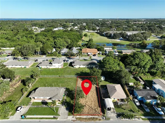an aerial view of residential houses with outdoor space and street view
