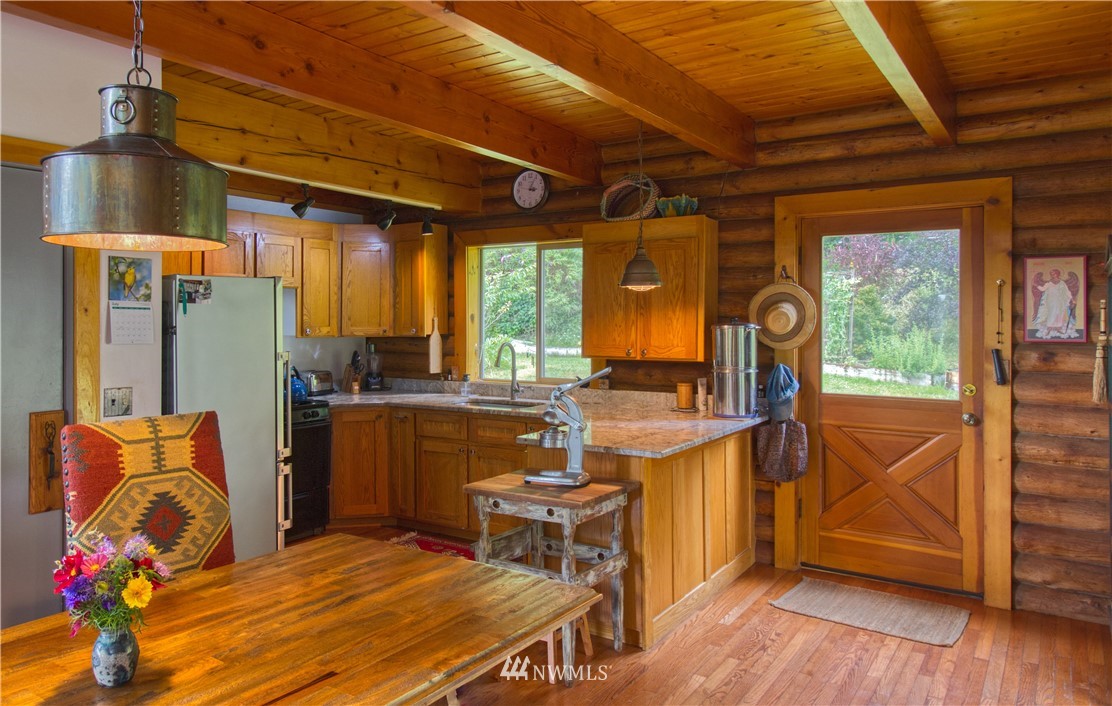 2707 Dabob Road Quilcene, WA 98376 - Photo 11 of 36 a dining room with furniture and wooden floor