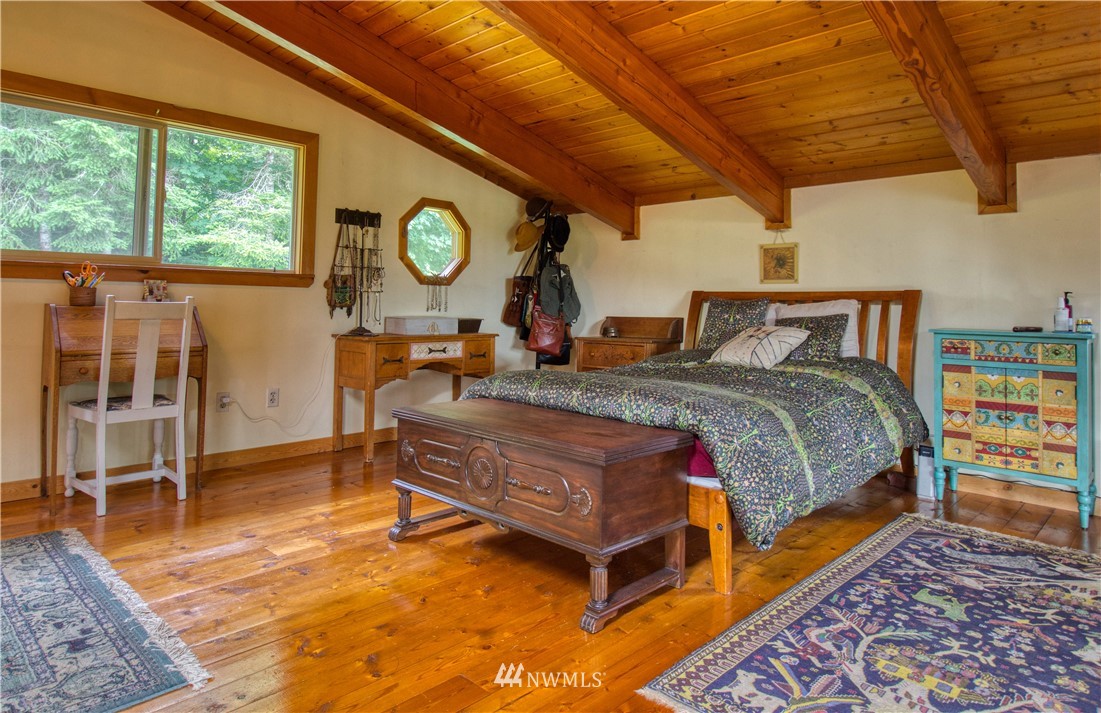 2707 Dabob Road Quilcene, WA 98376 - Photo 15 of 36 a bed sitting in a bedroom next to a window