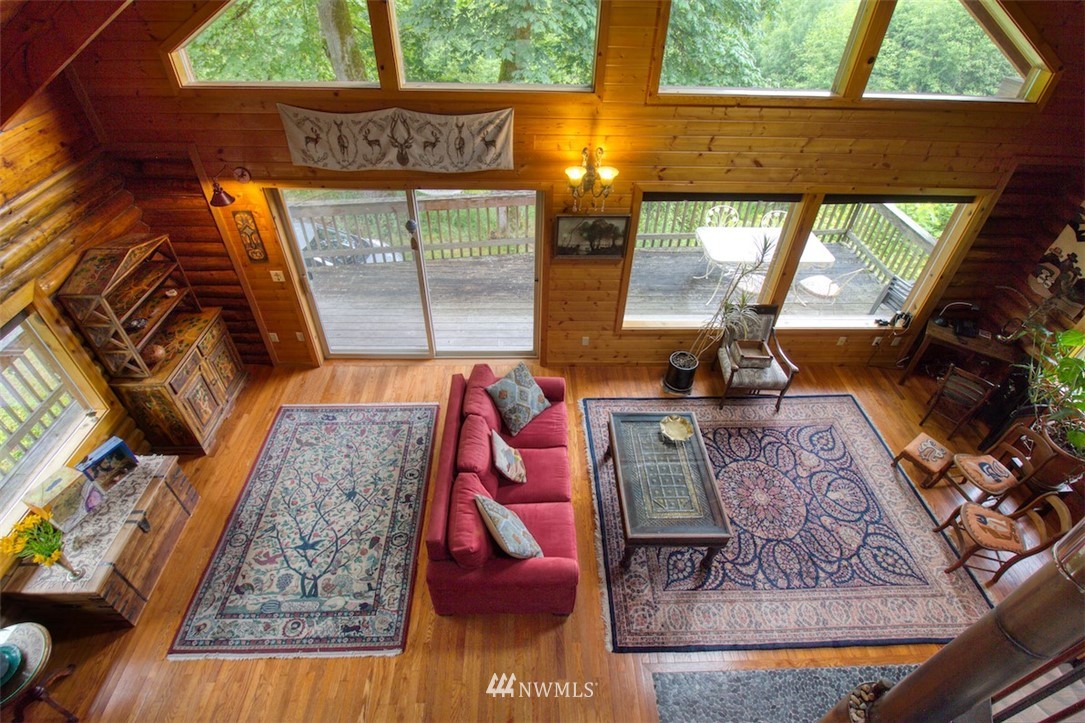 2707 Dabob Road Quilcene, WA 98376 - Photo 16 of 36 a living room with furniture and a floor to ceiling window