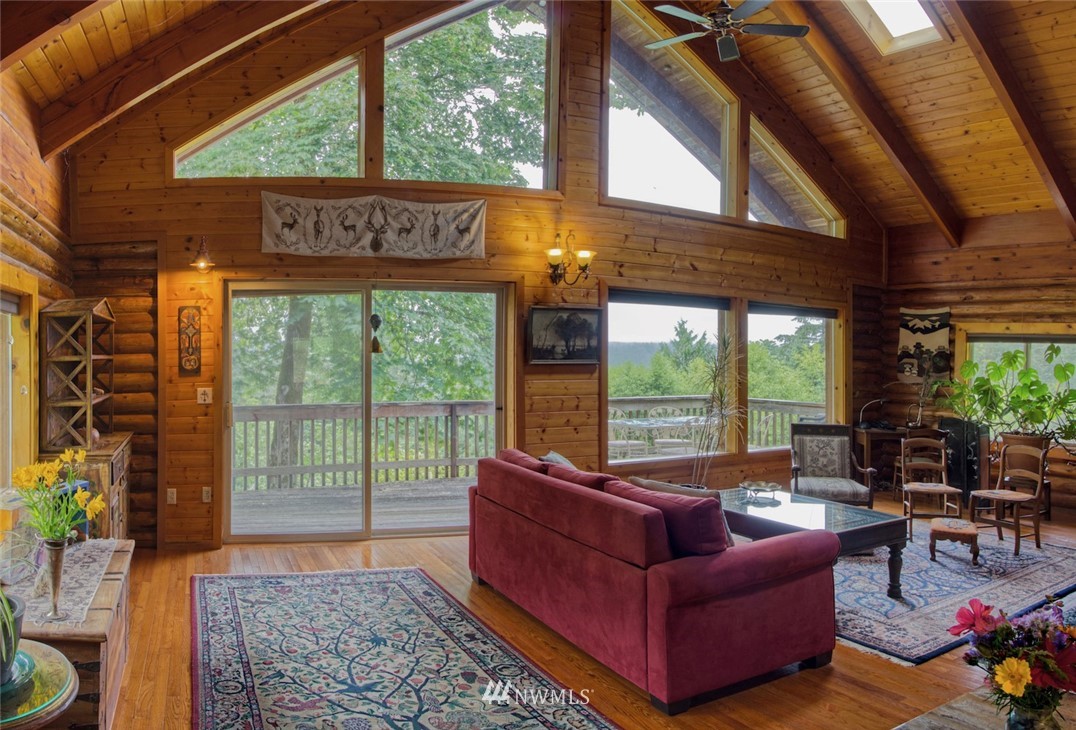 2707 Dabob Road Quilcene, WA 98376 - Photo 3 of 36 a living room with furniture and a floor to ceiling window