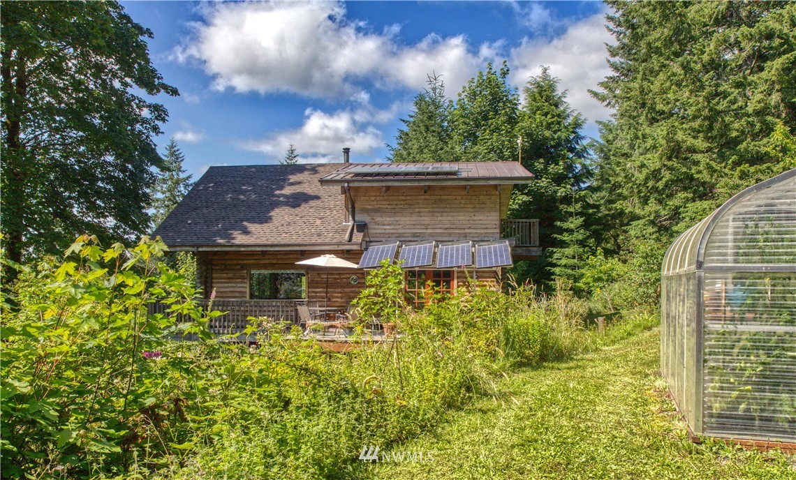 2707 Dabob Road Quilcene, WA 98376 - Photo 28 of 36 front view of a house with a yard
