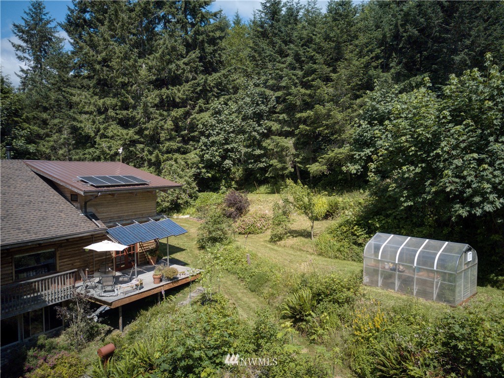 2707 Dabob Road Quilcene, WA 98376 - Photo 31 of 36 an aerial view of a house with a garden and lake view