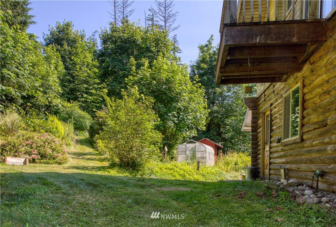 2707 Dabob Road Quilcene, WA 98376 - Photo 32 of 36 a backyard of a house with lots of green space