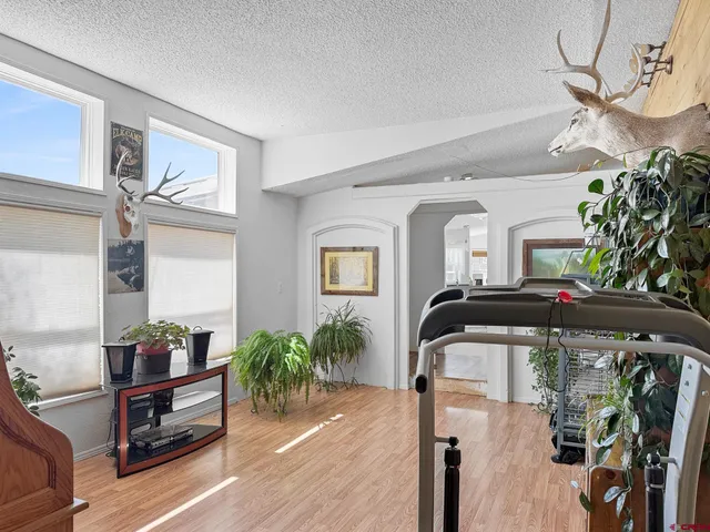 a living room with furniture and a mirror