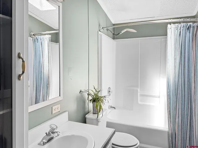 a bath room with a sink and a mirror