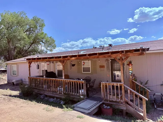 a view of a house with a yard and sitting area