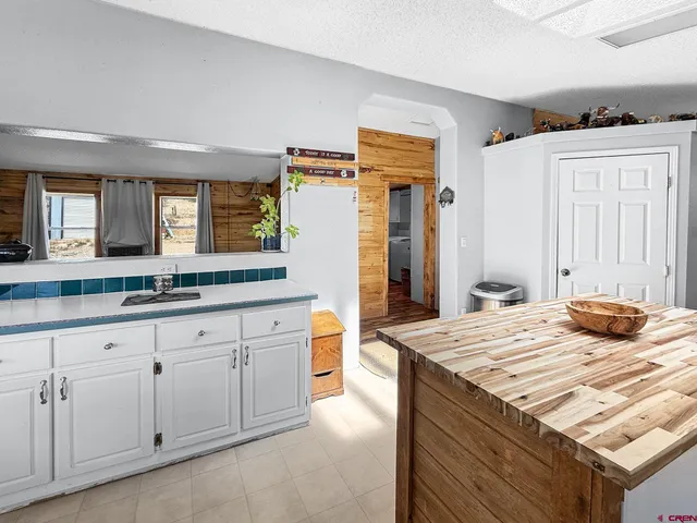 a kitchen with granite countertop a sink and cabinets