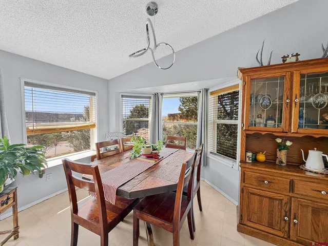 a view of a dining room with furniture window and outside view