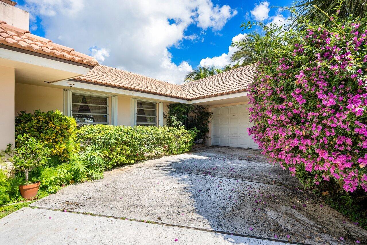 7 Sabal Island Drive Ocean Ridge, FL 33435 - Photo 16 of 44 a view of a house with a flower garden