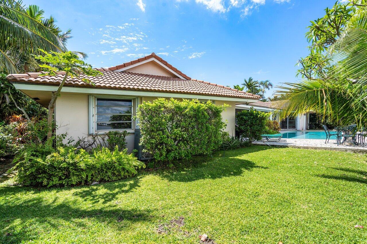 7 Sabal Island Drive Ocean Ridge, FL 33435 - Photo 18 of 44 a front view of a house with a yard